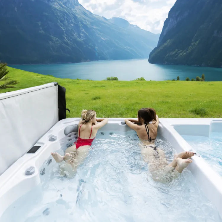 women relax in the outdoor swim spa