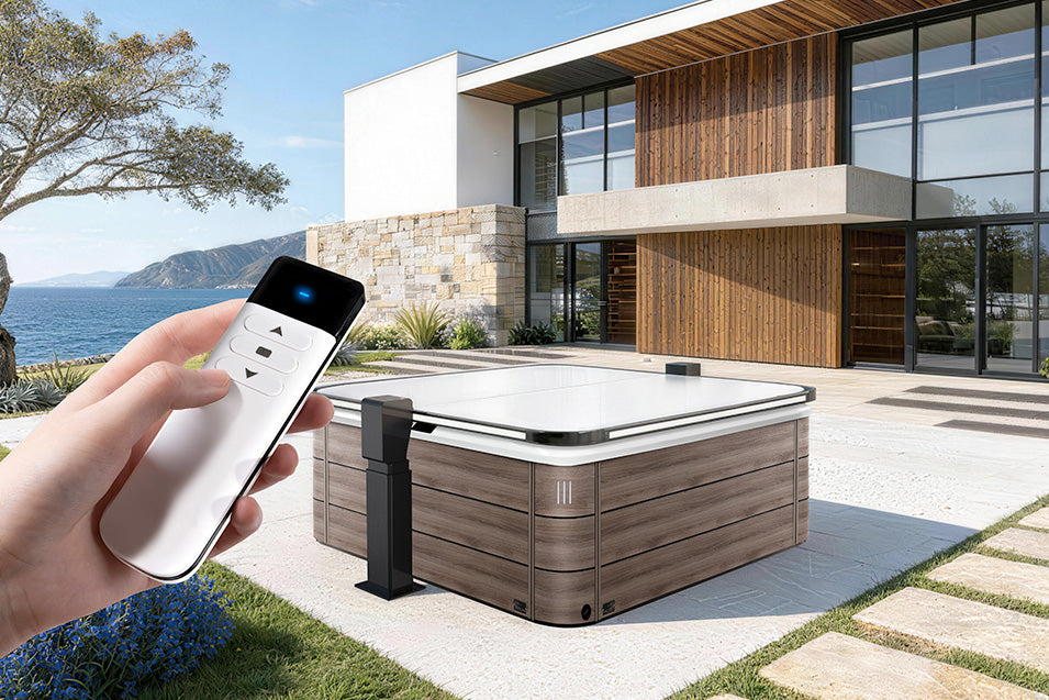Hand holding a remote control near a hot tub