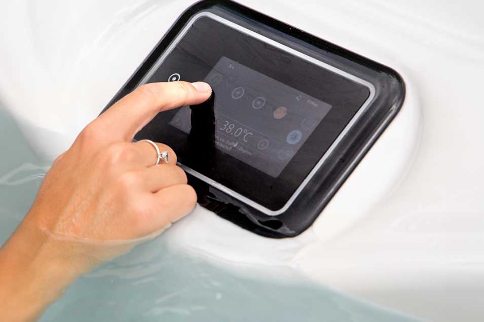 Woman hand interacting with the gecko Infinity controller of the hot tub