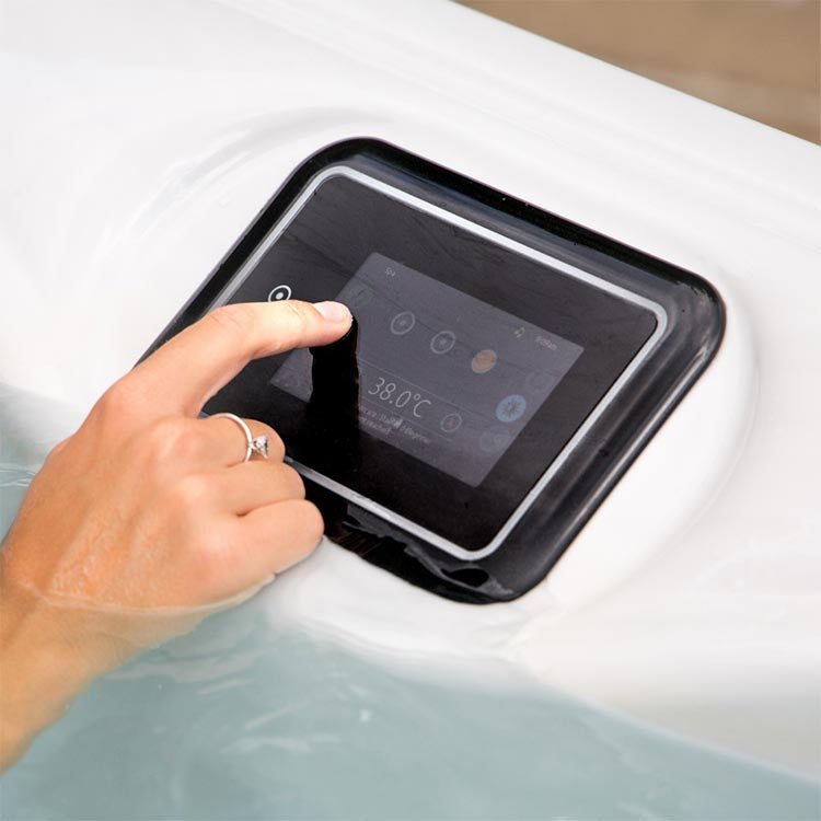 Woman hand interacting with the gecko Infinity controller of the hot tub