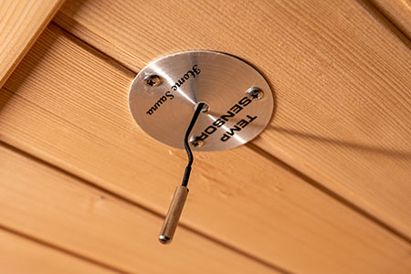 Metal temperature gauge on a wooden surface