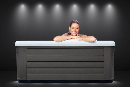 a woman lying on the edge of the spa
