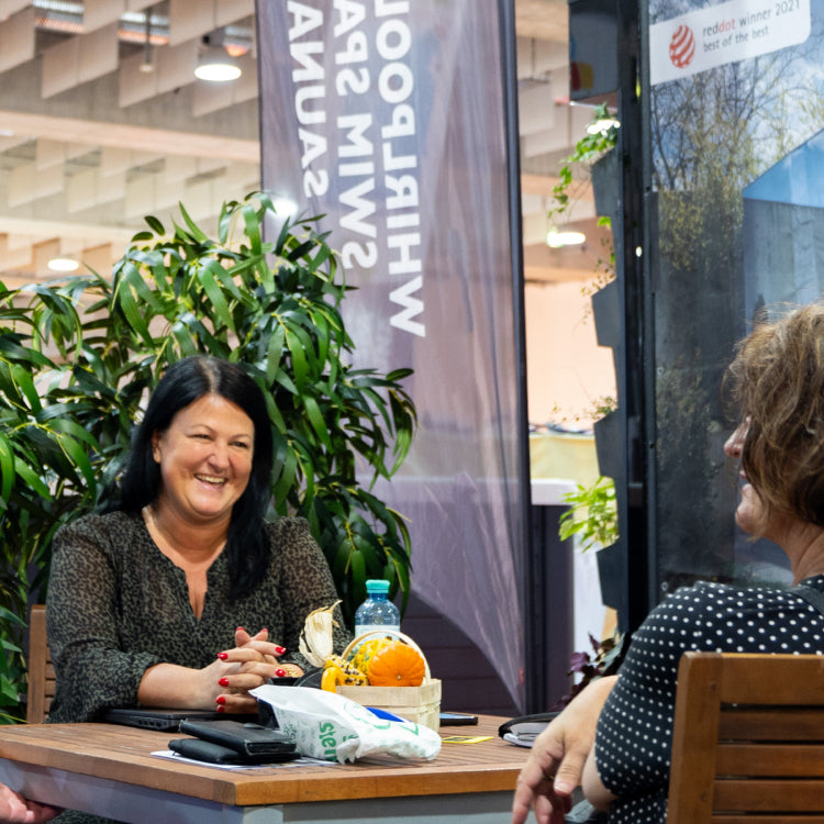 Sale woman laughing and talking to customers