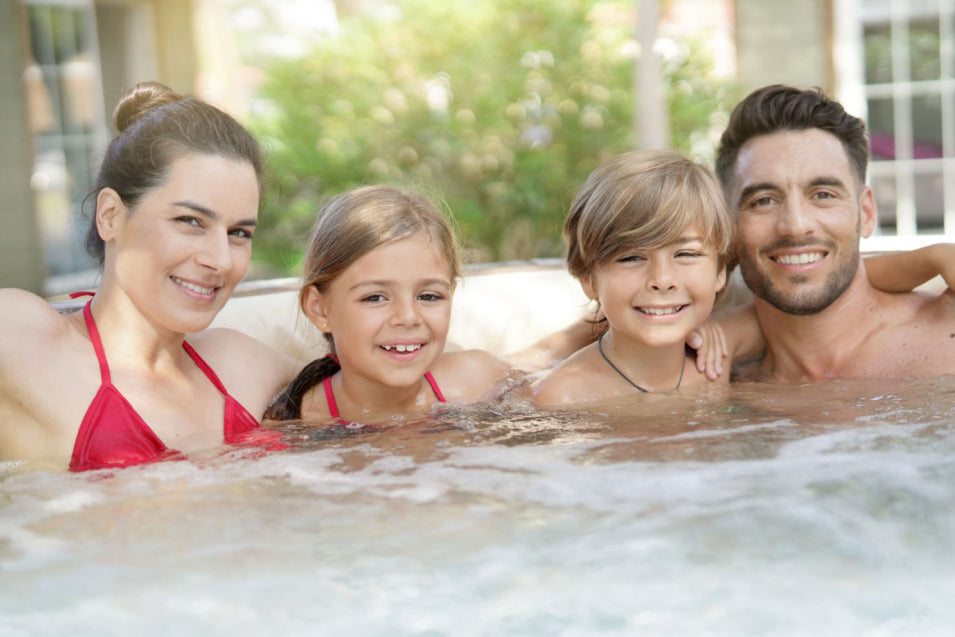 Family posing inside the hot tub