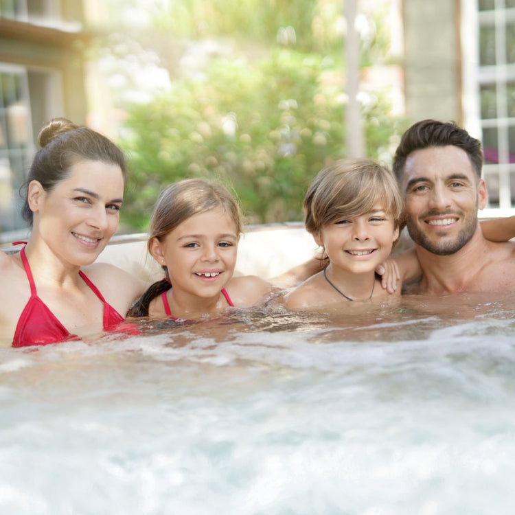 Family posing inside the hot tub