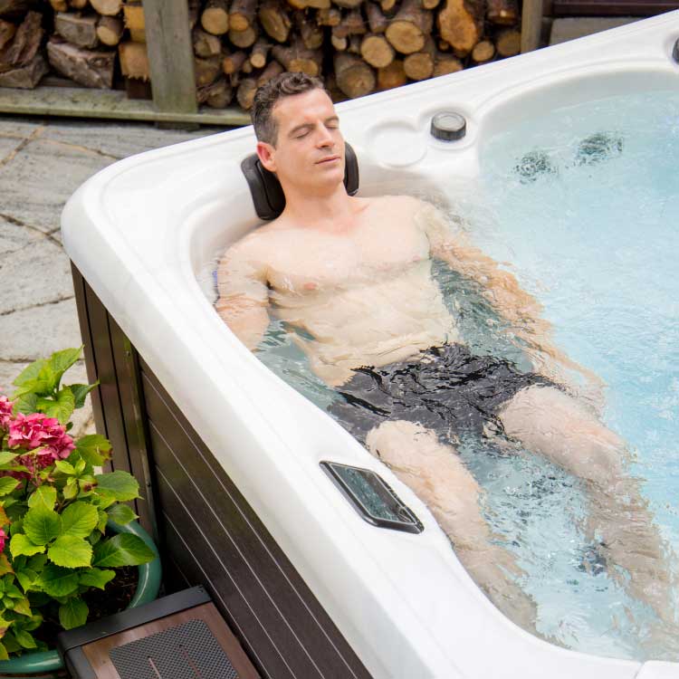Man enjoying the ultimate comfort in hot tub Starlight