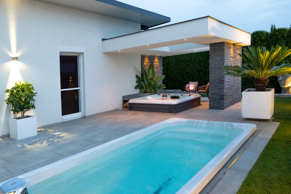 modern backyard with a fully inground swim spa and a hot tub